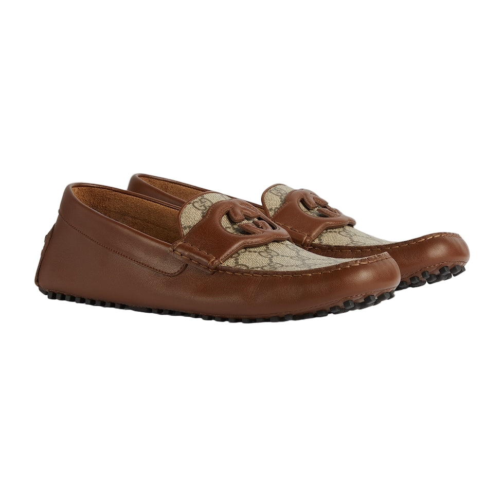 Pair of brown leather loafers with a textured pattern on a light gray background