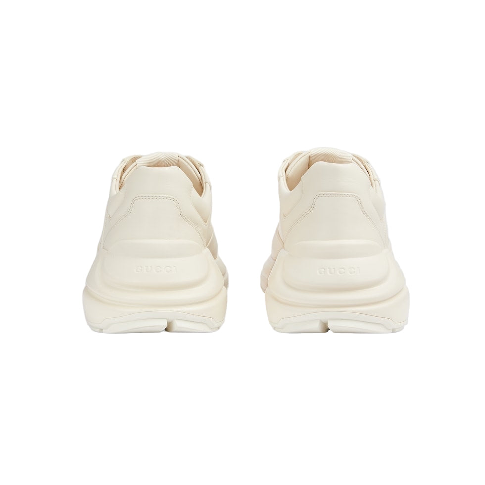 Pair of cream-colored sneakers on a light gray background