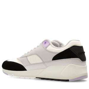 White sneaker with black and purple accents on a white background