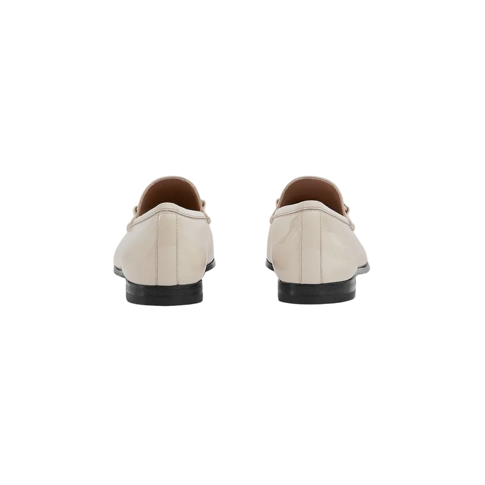 Pair of beige loafers on a light gray background