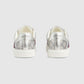 Silver Gucci sneakers with floral pattern on a light gray background
