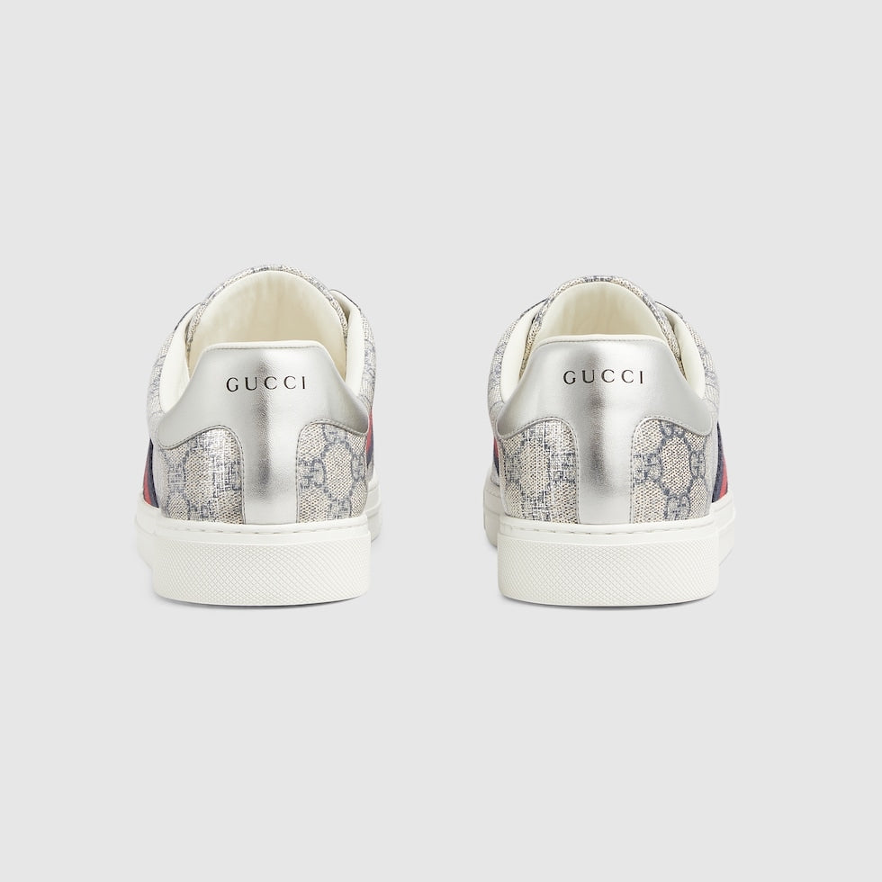 Silver Gucci sneakers with floral pattern on a light gray background