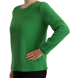 Green long-sleeve top worn by a person on a white background
