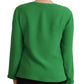 Green long-sleeve top worn by a person on a white background