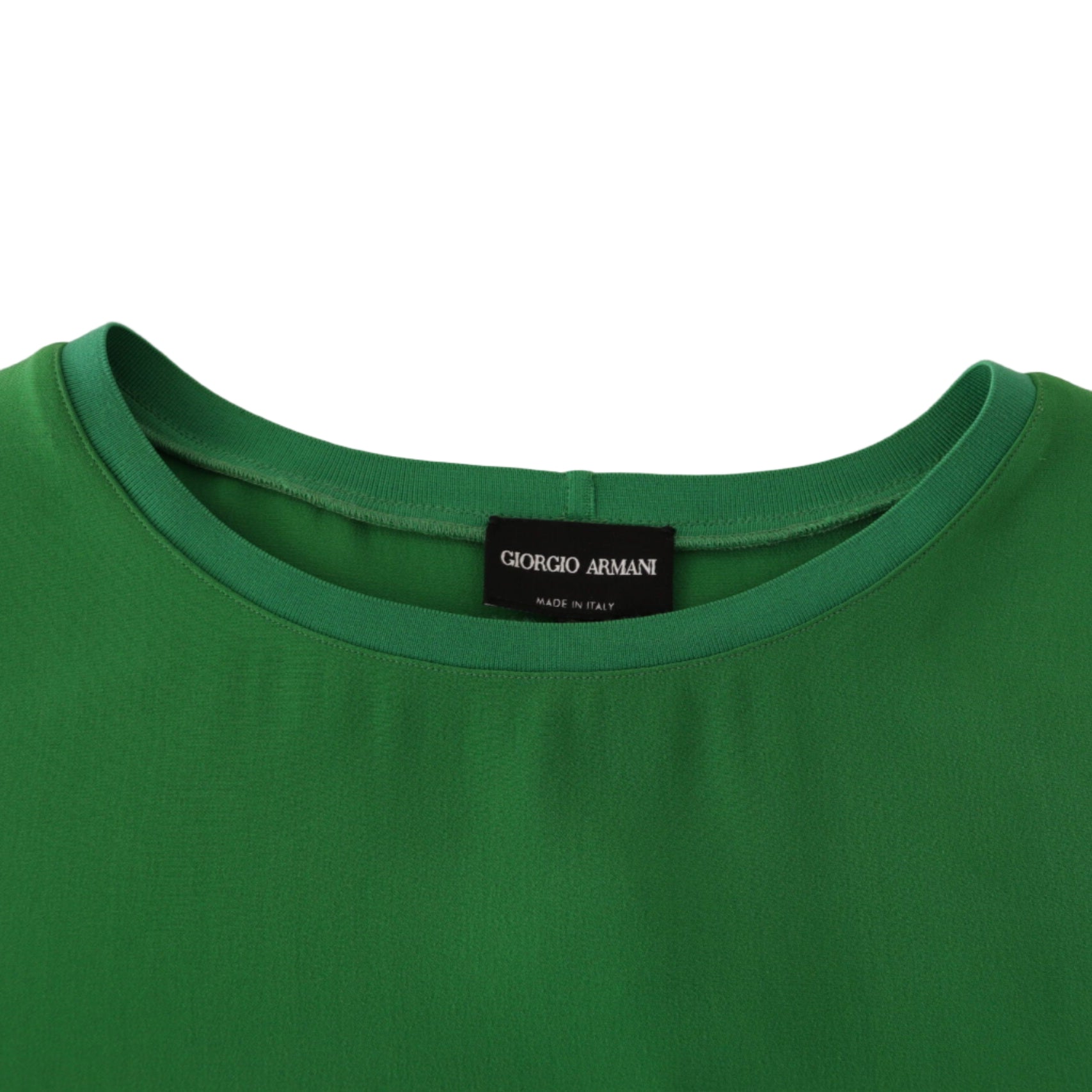 Green shirt with a Giorgio Armani label on a beige background