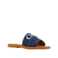 Blue sandal with a brown sole on a white background