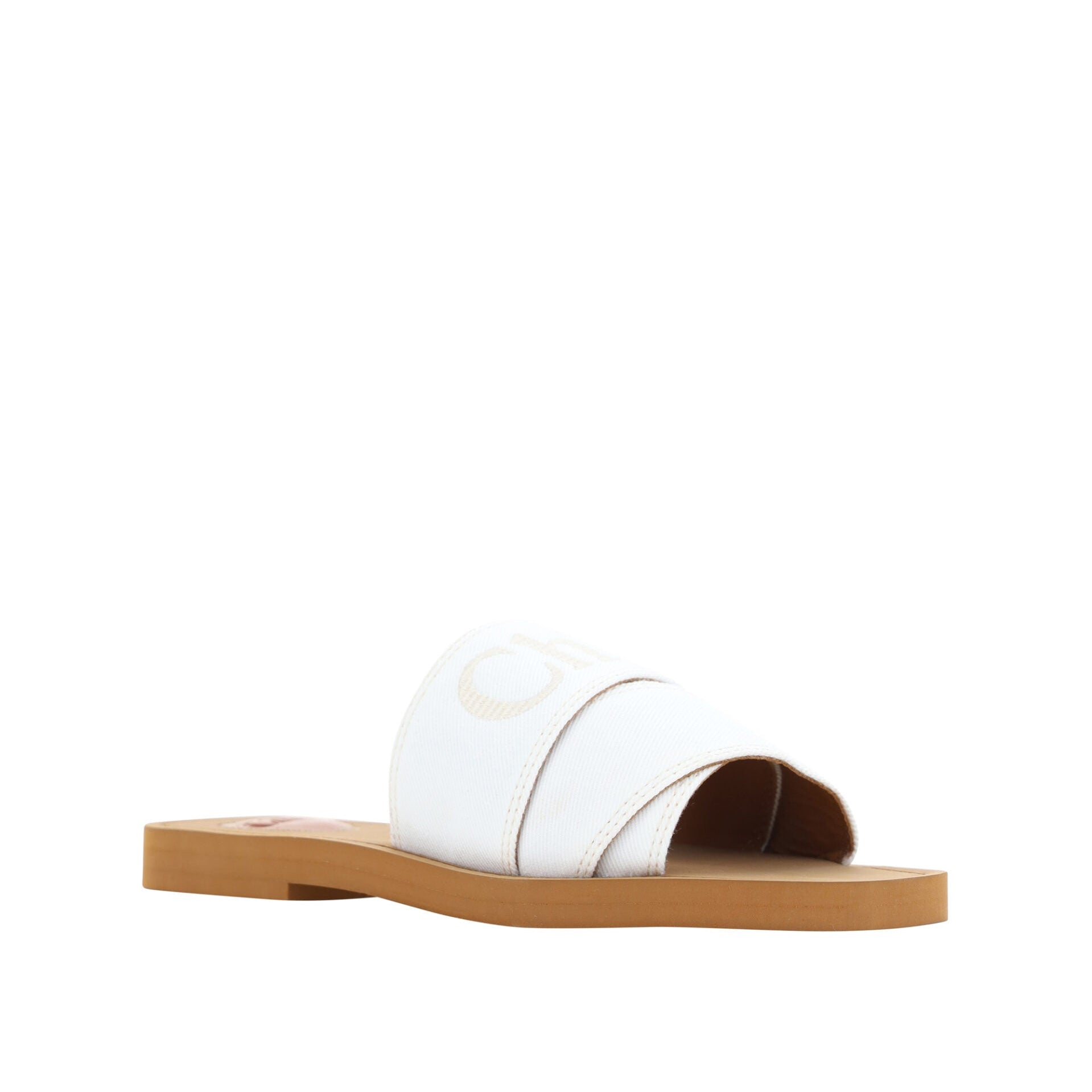 White sandal with a brown sole on a white background
