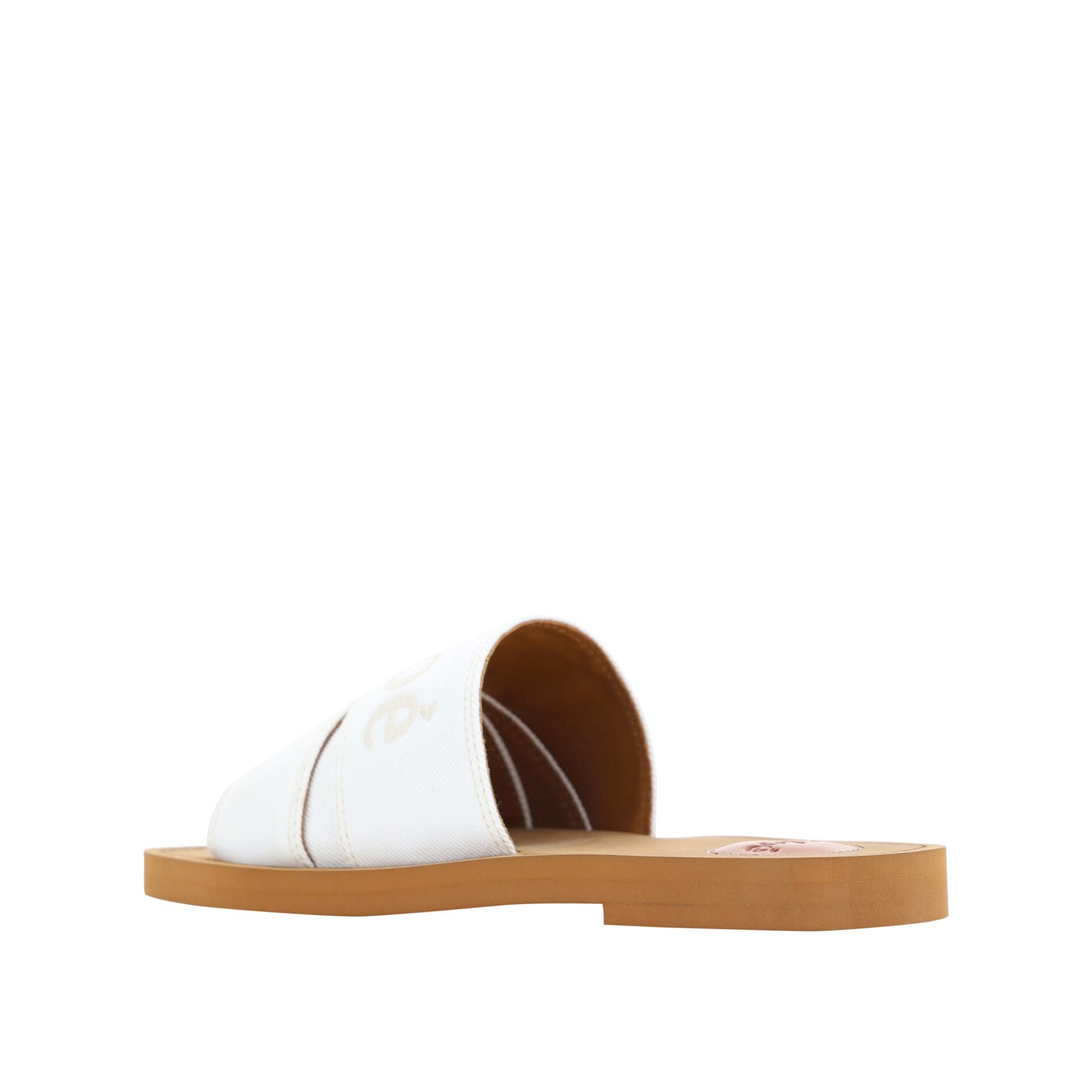 White sandal with brown sole on a white background