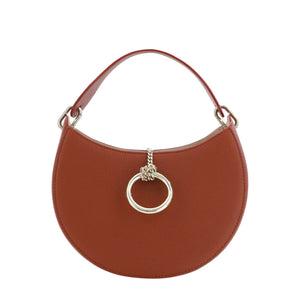 Brown handbag with a gold ring detail on a white background