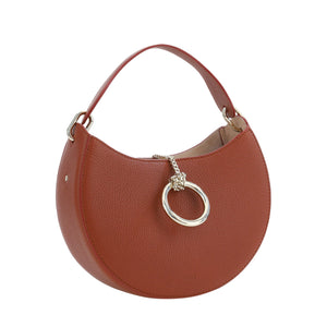 Brown handbag with a silver ring detail on a white background