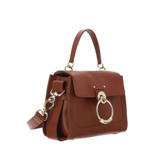 Brown handbag with gold accents on a white background