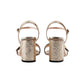 Gold glittery high-heeled sandals on a white background