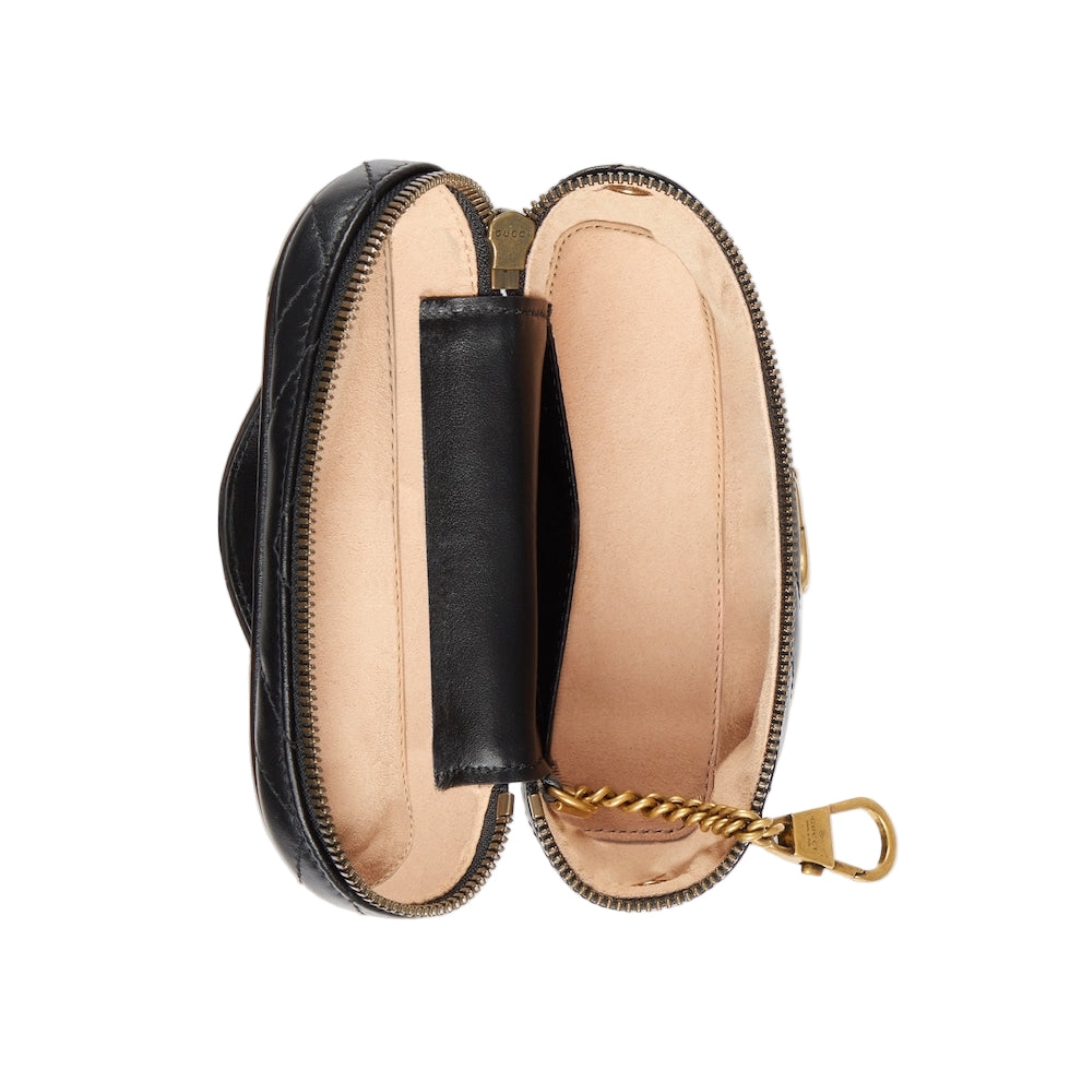 Close-up of a black leather pouch with gold zipper on a light gray background