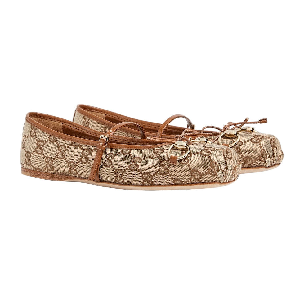 Pair of beige and brown patterned flats on a light gray background