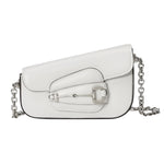 White Gucci horsebit handbag with a chain strap on a light gray background