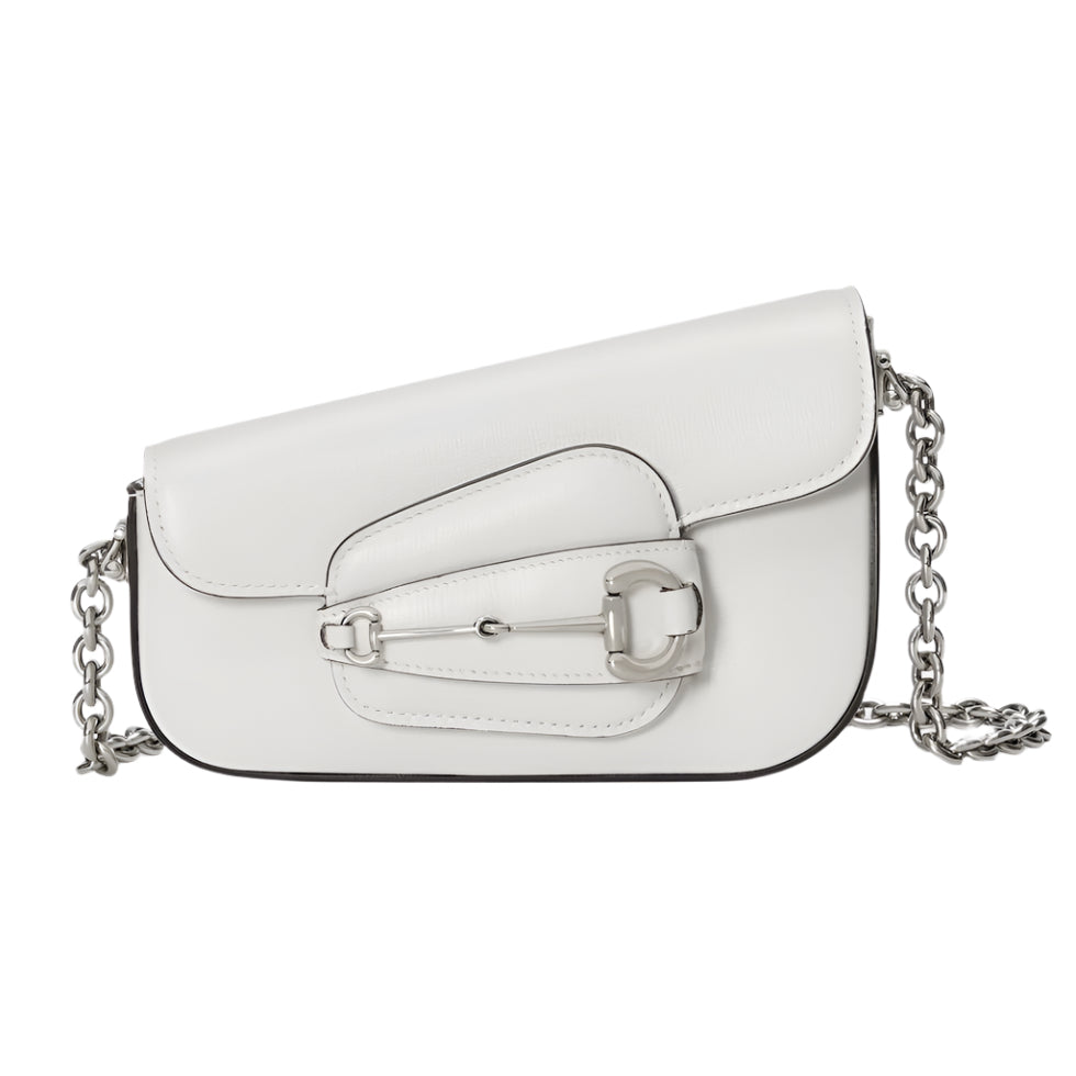White Gucci horsebit handbag with a chain strap on a light gray background