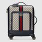 Designer suitcase with patterned exterior and visible brand logo on a light gray background