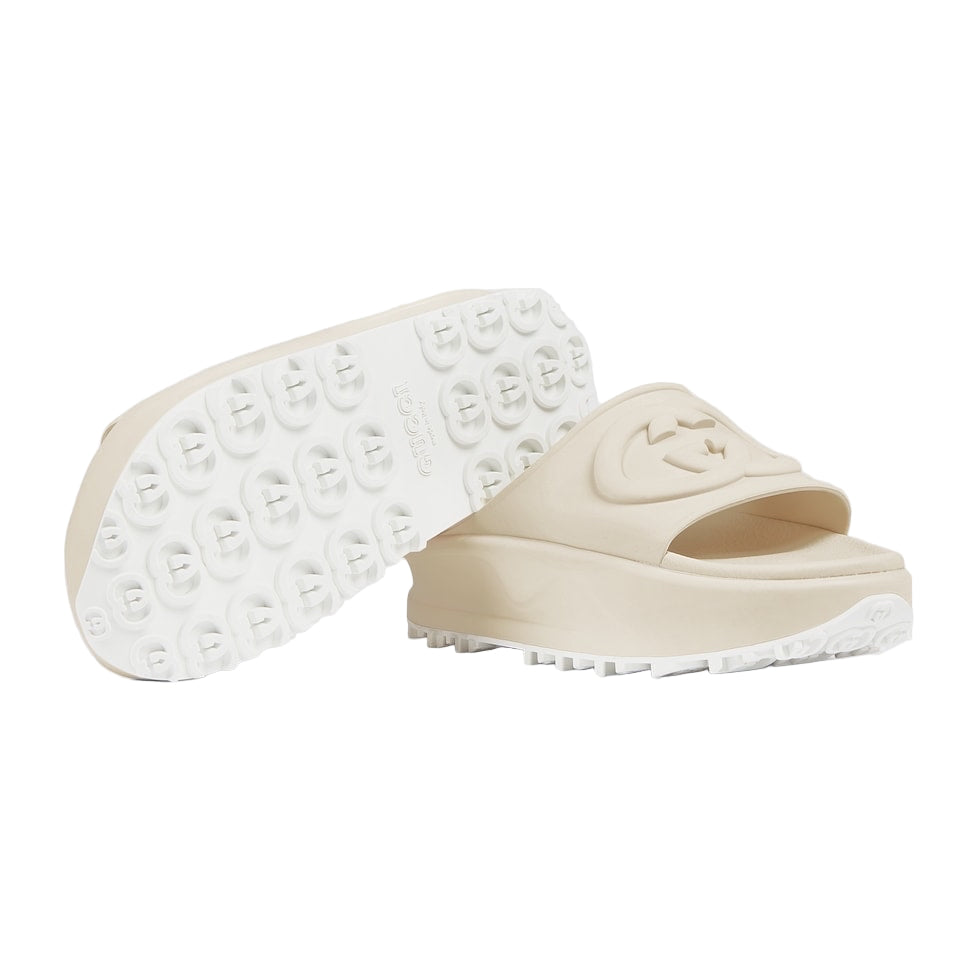 Beige slide sandal with white sole on a light gray background