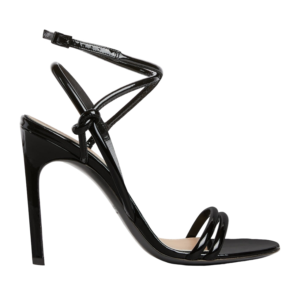 Black high-heeled sandal with thin straps on a light gray background