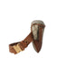 Dog muzzle with Gucci pattern and brown leather strap on a light gray background