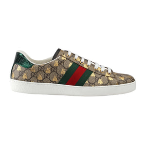 Gucci sneaker with patterned design and iconic green and red stripe on a light gray background