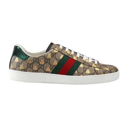 Gucci sneaker with patterned design and iconic green and red stripe on a light gray background