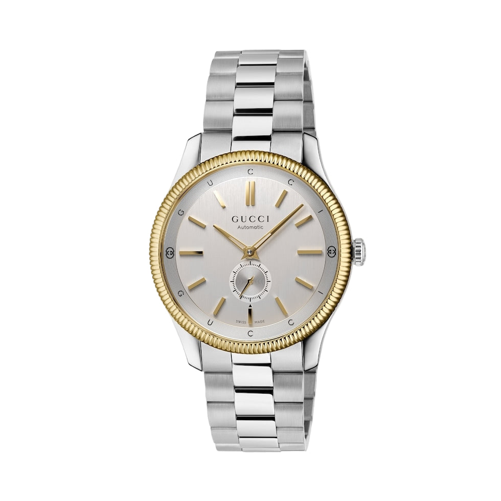 Gucci watch with silver and gold band on a light gray background