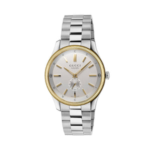 Gucci watch with silver and gold band on a light gray background