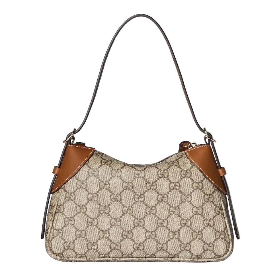 Designer handbag with patterned surface and brown accents on a light gray background