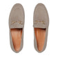 Pair of beige loafers with gold accents on a light gray background