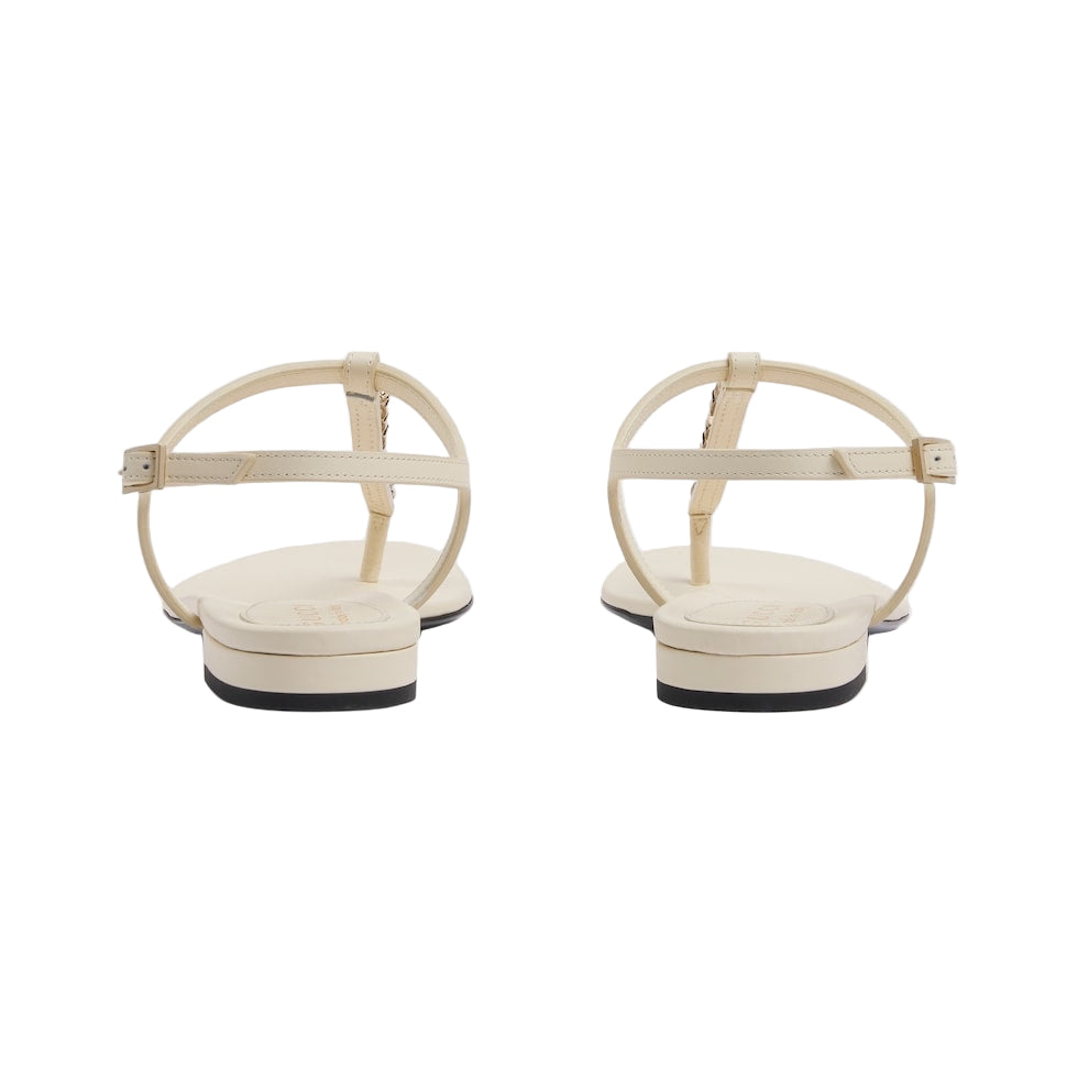 Pair of beige sandals with open-toe design on a white background
