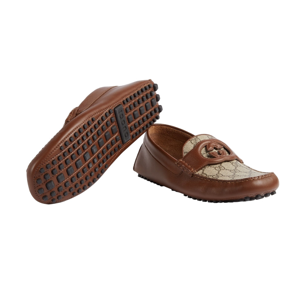 Brown loafers with patterned design on a light gray background