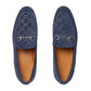 Pair of blue suede loafers with Gucci logo on a light gray background