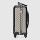 Patterned suitcase with black accents on a light gray background