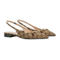 Pair of beige slingback flats with Gucci logo on a light gray background