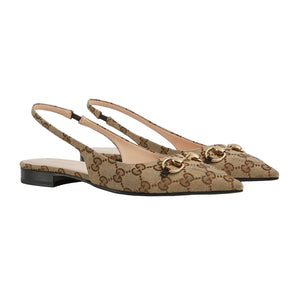 Pair of beige slingback flats with Gucci logo on a light gray background