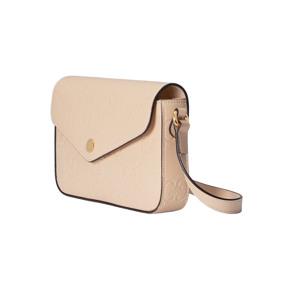 Beige handbag with a gold clasp on a light gray background