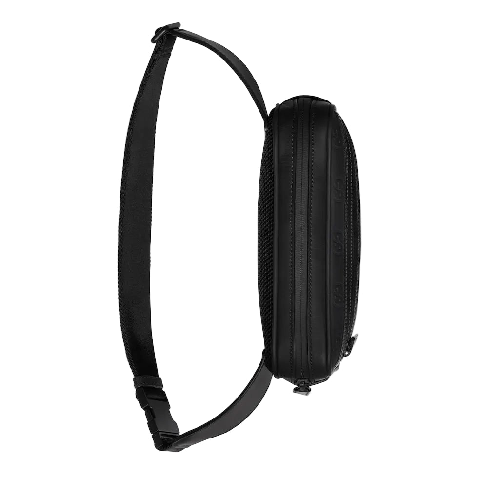 Black crossbody bag with a strap on a light gray background