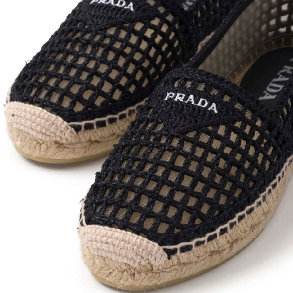 Black Prada espadrilles with jute sole on a white background
