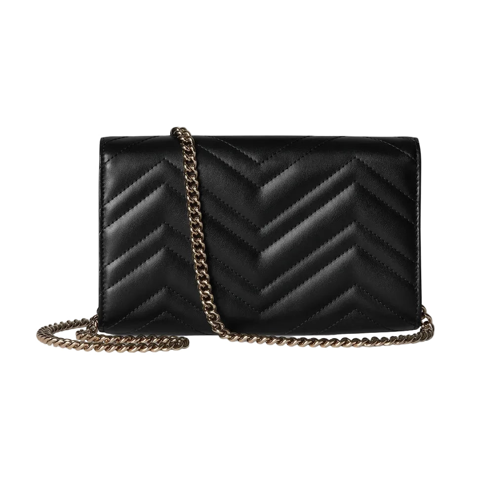 Black chevron-patterned handbag with a gold chain strap on a light gray background