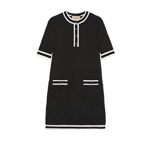 Black dress with white accents on a light gray background