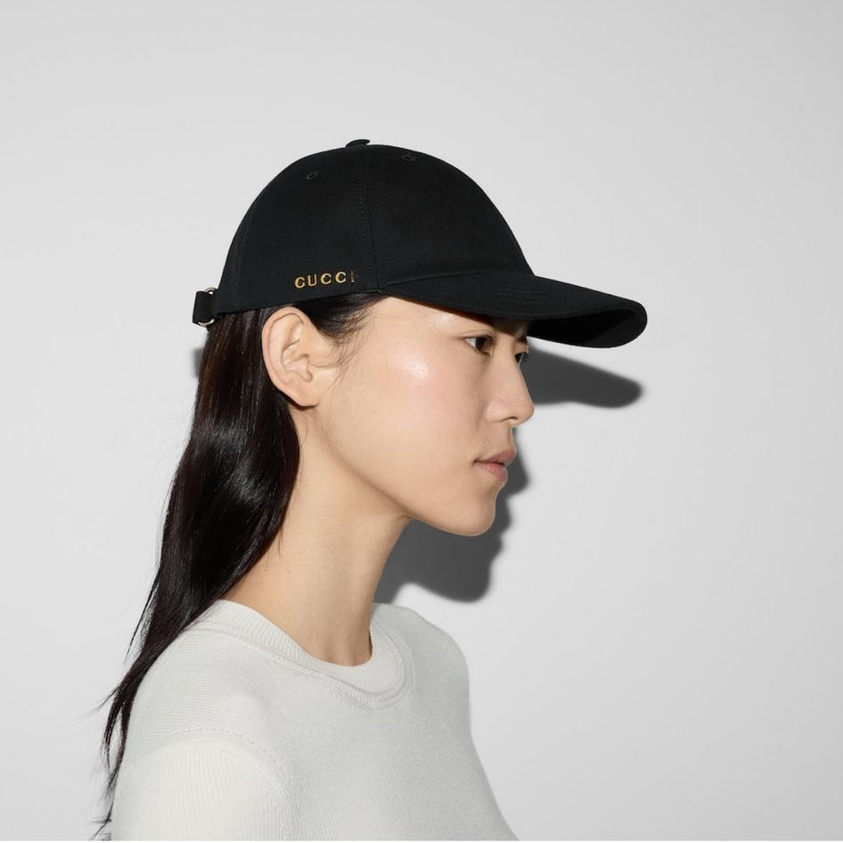 Person wearing a black cap with text on a white background