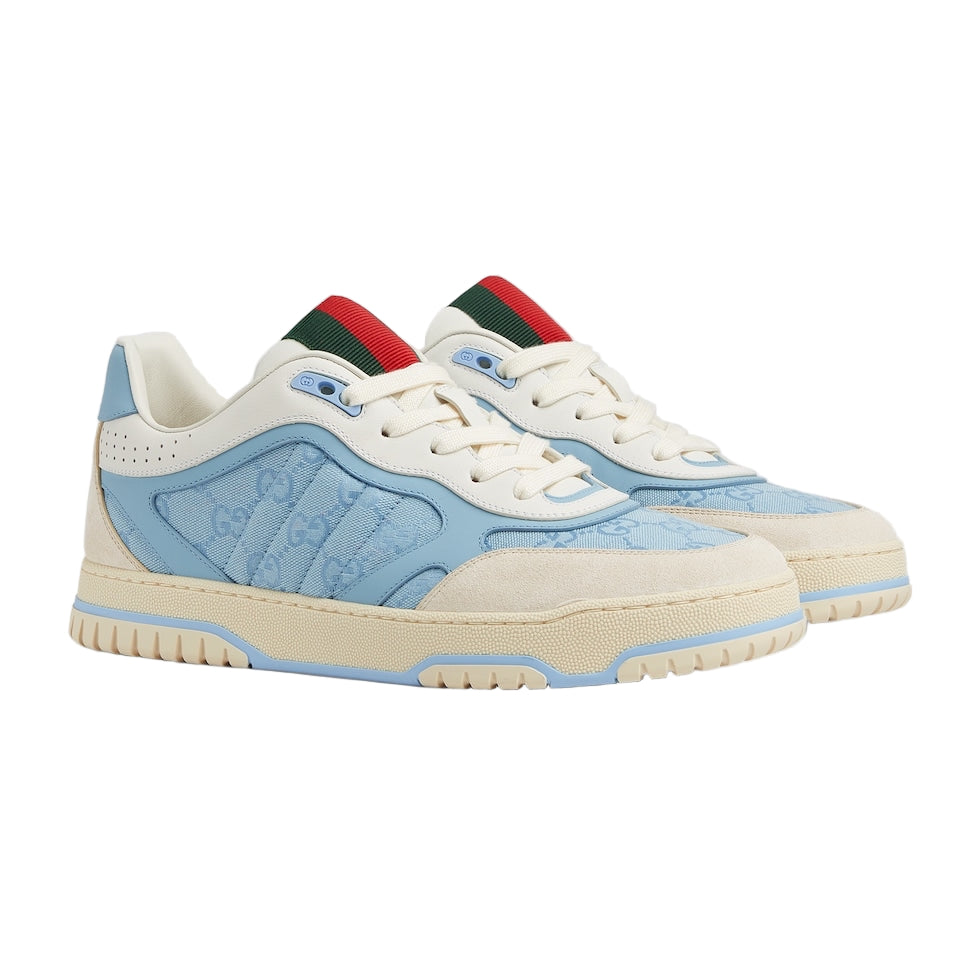 Pair of sneakers with blue and beige design on a light gray background