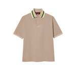 Beige Gucci polo shirt with a brand logo on a white background
