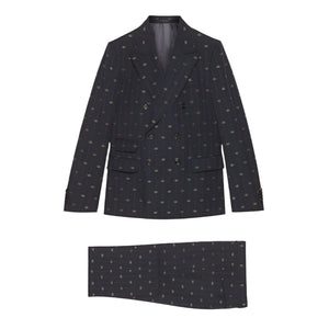 Dark patterned  Gucci GG blazer and matching pocket square on a light gray background