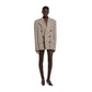 Person wearing a beige double-breasted blazer on a white background