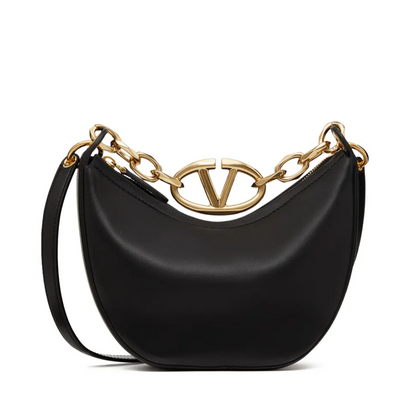 Black handbag with gold chain detail on a white background