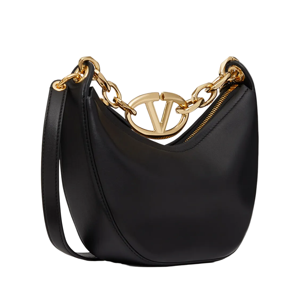 Black handbag with gold chain and logo on a white background