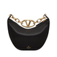 Black handbag with gold chain and logo on a white background