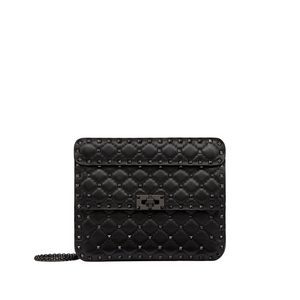 Black quilted wallet with chain strap on a light gray background